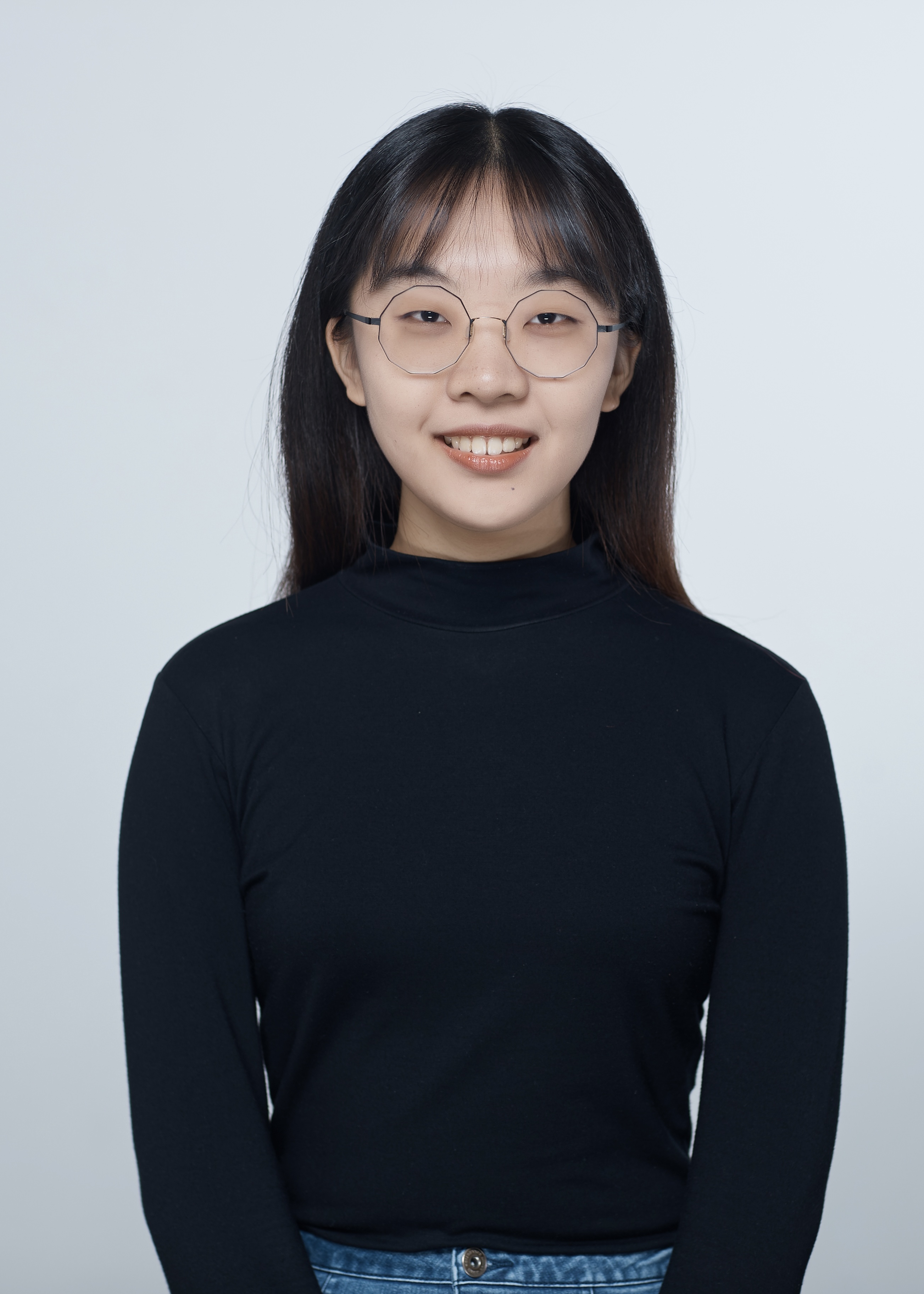 A Chinese girl with long black hair, wearing glasses and a black shirt.